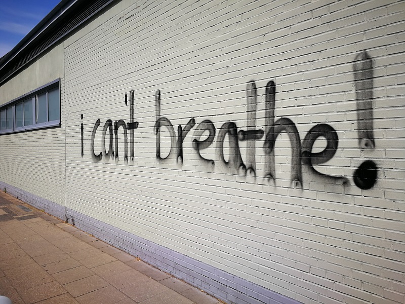 Graffiti artwork featuring the phrase "I can't breathe," symbolising social justice and the fight against oppression.