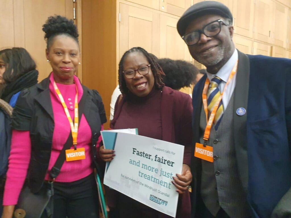 Paulette Wilson MP holds pledge card with Windrush supporters