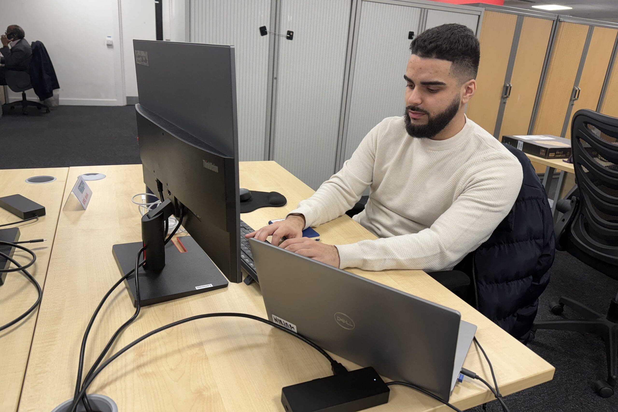 Man at his desk typing on Computer keyboard.