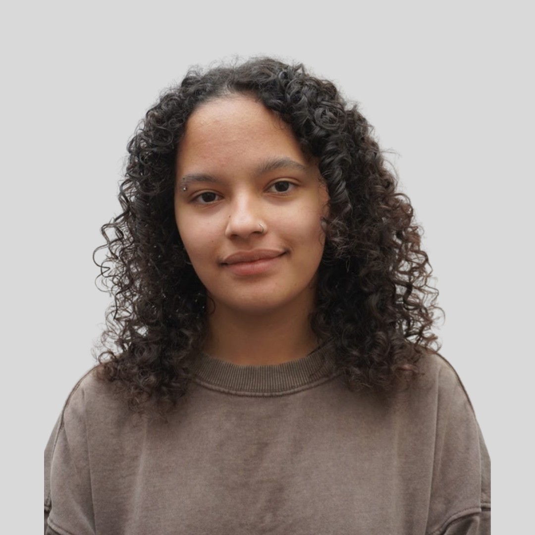 lady with curly hair smiling at camera
